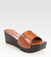 Sprinkled in studs, this traditional leather style has a slight wooden wedge and platform. Wooden wedge, 2½ (65mm)Wooden platform, 1½ (40mm)Compares to a 1 heel (25mm)Leather upperLeather lining and solePadded insoleMade in ItalyOUR FIT MODEL RECOMMENDS ordering one half size up as this style runs small. 