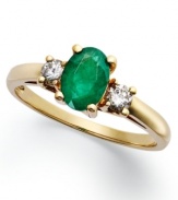 Enviable green hues. This vibrant 14k gold ring features an oval-cut emerald (7/8 ct. t.w.) and round-cut diamond side stones (1/5 ct. t.w.).