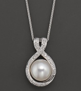 A large freshwater pearl pendant with diamond accents.