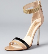 A chainmetal ankle strap and glossy patent leather add luxe details to Boutique 9's teetering pair of stiletto sandals.