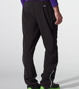 Designed for athletic endeavors and enhanced movement, a sleek athletic pant gets a modern update in stretch polyester jersey with sporty striped details at the sides.