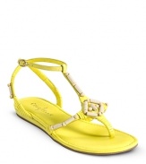 A beachy-chic flat sandal adorned with wood bead detail and a functional gold buckle. From Cole Haan.