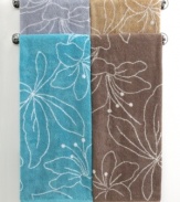 Your bath, in bloom. Featuring a stencil design of modern lilies, this Bianca hand towel blossoms in refreshing hues and soft terry. Contrast pattern on reverse.