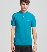 A classic polo from Burberry in a vibrant malachite hue.