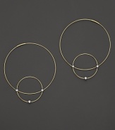 Like magic, smaller hoops balance on 14K gold counterparts.