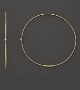 Single diamonds wink from the center of these delicate 14K gold hoops.