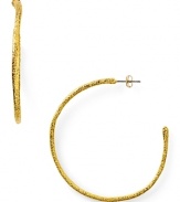 Designer Alexis Bittar plays rough with these textured gold plated hoop earrings, boasting a simple shape and faceted finish.