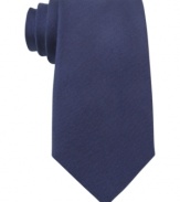 A solid statement. Score a singular look with this silk tie from Tommy Hilfiger.