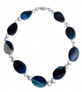 Multifaceted blue agate beads (32 mm) are separated with delicate cultured freshwater pearls (8 mm) in this brilliantly colored necklace to create a statement piece that truly captures the eye. Necklace set in sterling silver. Approximate length: 18 inches.