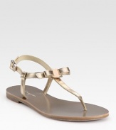 Adjustable metallic leather straps, sweetened by a dainty bow. Metallic leather upperLeather liningRubber solePadded insoleMade in ItalyOUR FIT MODEL RECOMMENDS ordering one half size down as this style runs large. 