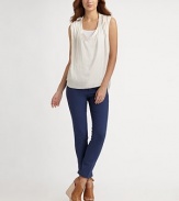 Ruched, glossy v-neck with a unique point collar and chic hi-low hem. Point collarRuched v-neckSleevelessHi-low hemPolyesterDry cleanImported