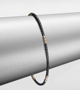 A simple chic piece that features faceted beads in blackened sterling silver accented with five, 14k gold beaded sections. Blackened sterling silver14k goldDiameter, about 2.5Slip-on styleMade in USA