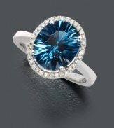 Absolutely mesmerizing. Add a hint of sparkle with oval-cut concave London blue topaz (4 ct. t.w.) embellished with a ring of round-cut diamonds (1/8 ct. t.w.). Set in 14k white gold.