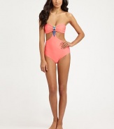 An exotic swim style that shows just the right amount of skin, thanks to sexy cutout details. Bandeau topCutout detailsBeaded centerBack clasp closureFully lined80% nylon/20% spandexHand washImported