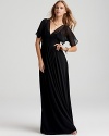 Effortlessly elegant, this BCBGMAXAZRIA flutter-sleeve gown not only makes a dramatic entrance, but a dramatic exit-thanks to a romantic lace back.