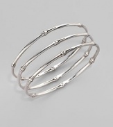 From the Bamboo Collection. Slim and elegant in fine sterling silver, this set of three bangles displays the graceful pattern of bamboo. This design was expressly created to support an afforestation project on Nusa Penida, an arid island off the coast of Bali. For every purchase, John Hardy will donate a portion of the retail price to the cost of planting bamboo. This bangle set helped plant 6 bamboo seedlings. Sterling silver Diameter, about 2½ Set of 3 Made in Bali