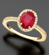 An oval-cut ruby (1-3/8 ct. t.w.) revels in a regal setting of 14k gold and round-cut diamonds (1/4 ct. t.w.) on this Effy Collection ring.