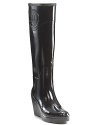 Sleek wedge rain boots with large logo emblem embossed on side.