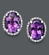 Pair your ensemble with a perfect touch of purple. These regal-looking stud earrings feature bright oval-cut amethyst (3 ct. t.w.) surrounded by a pretty ring of round-cut diamond (1/8 ct. t.w.). Crafted in 14k white gold. Approximate diameter: 1/2 inch.