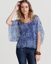 Fashioned in supple silk, this Ella Moss top boasts a billowy silhouette and bold print for fresh summer style.