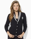 Inspired by Ivy League style, a classic cabled cardigan is crafted with a shawl collar and signature embroidery.