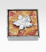 A cast maple leaf holds down a set of leaf-print napkins in a matching aluminum holder. Handmade Caspari napkins included 1½H X 5¾W X 5¾D Wipe clean Imported