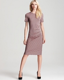 A silhouette that is all about shapes, this body-con Escada dress boasts a geometric print for forward fall style. Perfect for the office and chic after hours, the look is best punctuated by glossy platforms.