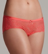 A soft lace hipster made from a smooth fabric with sheen, complete with a scalloped edge and bow at the center front.