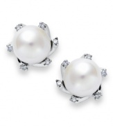 Inspired by heirloom jewelry, these traditional stud earrings feature an elegant mix of cultured freshwater pearls (7 mm) and sparkling diamond accents. Set in sterling silver. Approximate diameter: 1/2 inch.