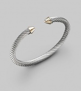 From the Cable Classics Collection. The essence of Yurman style in a simple, slender cable bangle, capped with domes of 14k gold. Sterling silver and 14k yellow gold Cable, 5mm Diameter, about 2¼ Imported