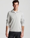 Sleek 1/4 zip sweater with woven textures at shoulder and sleeve.