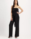 The contemporary jumpsuit gets a feminine touch in a filmy silk georgette flounceStraplessFlounce drapes from bodice to lower backSelf-beltWide legsInseam, about 44SilkDry cleanImported