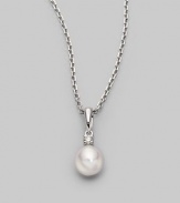 Simple and lovely, a white, round cultured Akoya pearl has a sparkling diamond accent, plus a chain and setting of 18k gold. 7mm white round cultured pearl Quality: A+ Diamond, 0.05 tcw 18k white gold Length, about 18 Spring ring clasp Imported