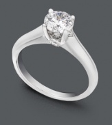 A timeless beauty symbolic of everlasting love. A sparkling round-cut solitaire diamond (9/10 ct. t.w.) sits in a shining 18k white gold setting. Ring features a single round-cut diamond (1/10 ct. t.w.) in a Milli-micro prong setting. IGI Certified diamonds.