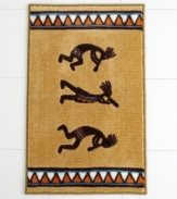 Revered by Native Americans, Kokopelli gives your bathroom an authentically Southwestern vibe. A colorful diamond pattern frames the dancing deity on this sand-colored bath rug.