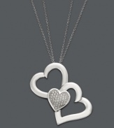 You'll do a triple take when you see this unique version of the iconic heart pendant. Treasured Hearts' beautifully-crafted design features two cut-out hearts and one solid heart dusted with sparkling, round-cut diamonds (1/5 ct. t.w.). Setting and chain crafted in sterling silver. Approximate length: 24 inches. Approximate drop: 1-1/4 inches.