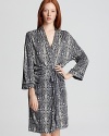 The snake skin trend goes nocturnal with this MARC BY MARC JACOBS robe. A serpent print embellished with chic black trim and a luxe touch of stretch delivers an effortless night-right look.