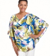 An elegant poncho silhouette gets revamped for spring with a vibrant floral print and sophisticated cowl neckline in this J Jones New York look.