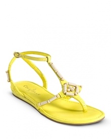 A beachy-chic flat sandal adorned with wood bead detail and a functional gold buckle. From Cole Haan.