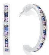 Traditions gives a sparkling boost to a simple pair of hoop earrings. A channel-set row of round-cut purple crystal with Swarovski elements shines within a sterling silver setting. Earrings feature a post and stud backing. Approximate diameter: 3/4 inch.