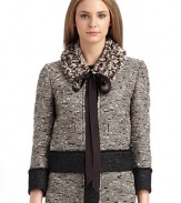 An intriguing design incredibly well-crafted from a rich bouclé tweed with contrasting textures and a detachable collar.Roundneck Long sleeves Concealed front snap closure Contrast bouclé placket, cuffs and hem Front welt pockets Detachable collar adorned with multihued yarns and grosgrain ribbon ties About 20 from shoulder to hem Fully lined 65% wool/24% cotton/6% nylon/5% other fibers Dry clean Made in Italy