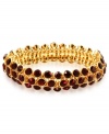 An elegant finishing touch from Anne Klein. Glass and plastic stones in red hues lend a look of romance to this bracelet. Crafted in gold tone mixed metal. Approximate diameter: 3 inches. Stretches to fit wrist.