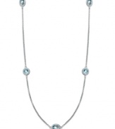 Long and luxurious. This pretty strand necklace features round and oval-cut stations of blue topaz (12 ct. t.w.) on a delicate sterling silver chain. Approximate length: 36 inches.