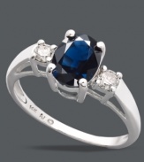 Add a simple touch of royalty to your look. This stunning, three stone ring highlights an oval-cut sapphire center stone (1-1/2 ct. t.w.) with round-cut diamonds (1/5 ct. t.w.) at the shoulders. Crafted in sterling silver. Size 7.