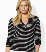 A deep split neckline finished with silver-toned buttons lends modern allure to a classic striped Henley in soft ribbed cotton.