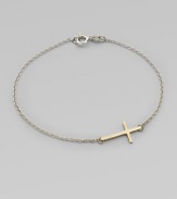 A simple, sleek cross of 14k gold sits sideways within a delicate sterling silver chain in this eloquent design.14k yellow gold and sterling silverLength, about 7Spring ring claspMade in USA