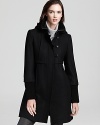 A knit collar and cuffs perfectly accents this babydoll-style DKNY coat, flaunting pretty pleats at the front and back and toggle closures for a charming finish.