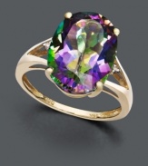 Let a faceted rainbow of color decorate your digits. A large oval-cut mystic topaz gemstone (7-1/6 ct. t.w.) sits in a split band 14k gold setting decorated with two diamond side accents.