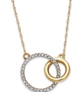 Slightly asymmetrical with a touch of shimmer, this double circle pendant embodies contemporary style. Crafted in 10k gold with sparkling round-cut diamonds adorning the larger circle. Approximate length: 17-1/2 inches. Approximate drop: 1/2 inch.