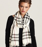 Burberry ups the glam factor with this check scarf in crinkled fabric with fringe trim. Let the signature pattern and luxurious proportions transform your look.